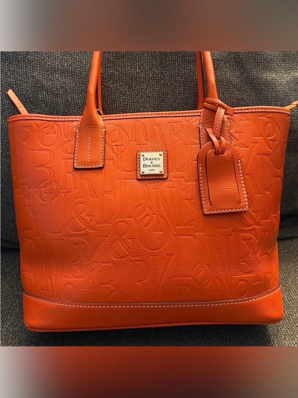 Dooney & Bourke Embossed Orange Leather Tote with Luggage Tag
